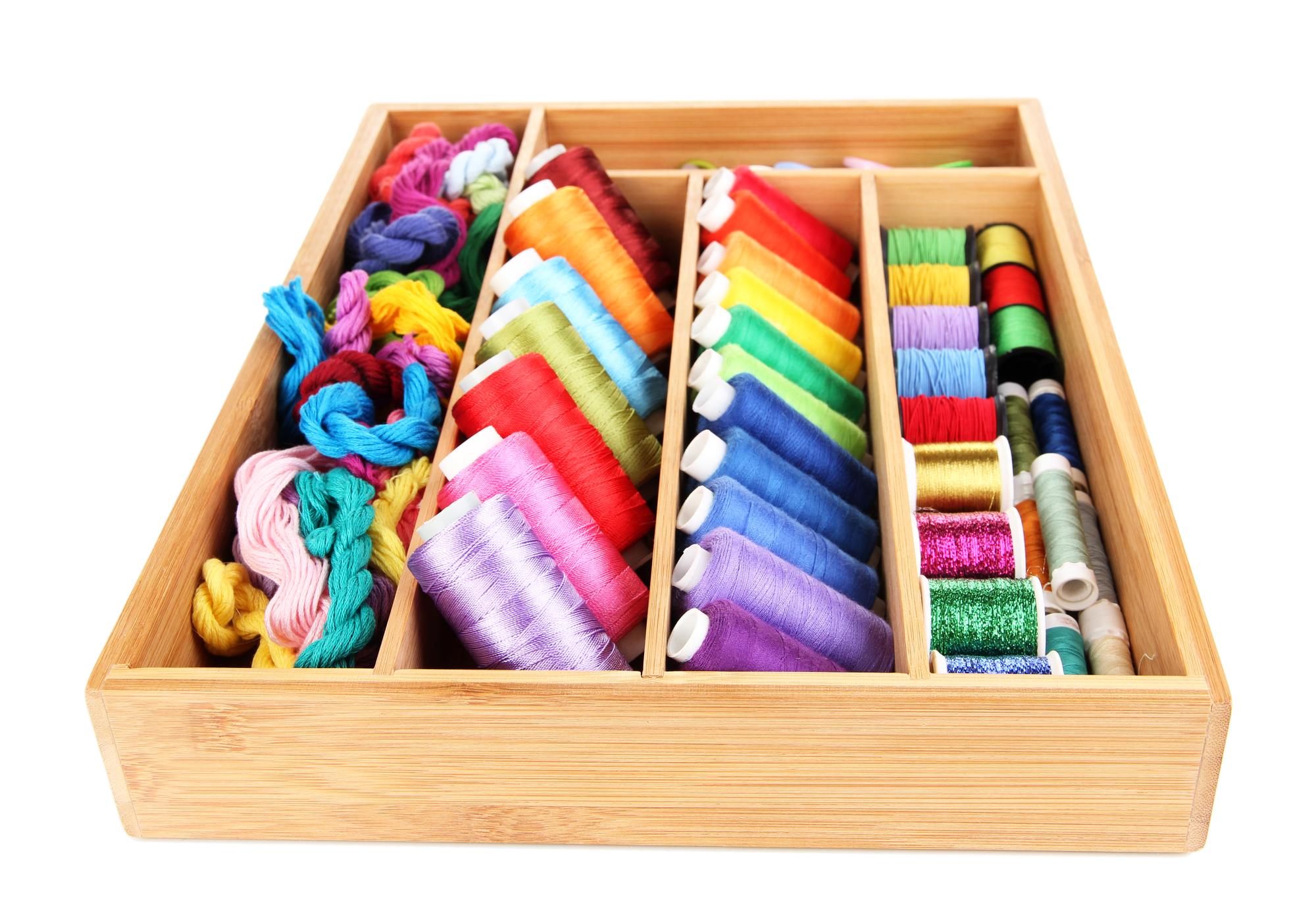 Collection of colored threads organized in tray